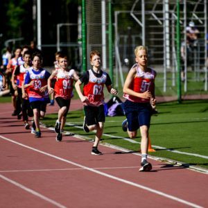 a group of young people running on a track